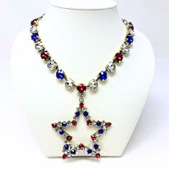 Gold chain necklace with red, clear, and blue crystal beads and a star pendant.