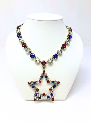 Gold chain necklace with red, clear, and blue crystal beads and a star pendant.