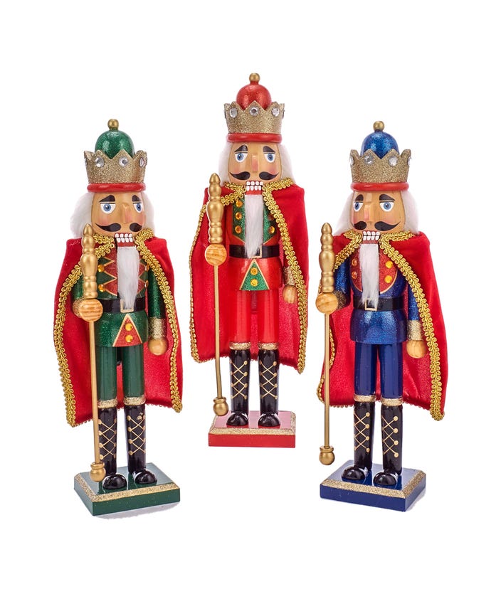 Wooden nutcracker soldier figurine in red cape with gold trim standing on a black base.