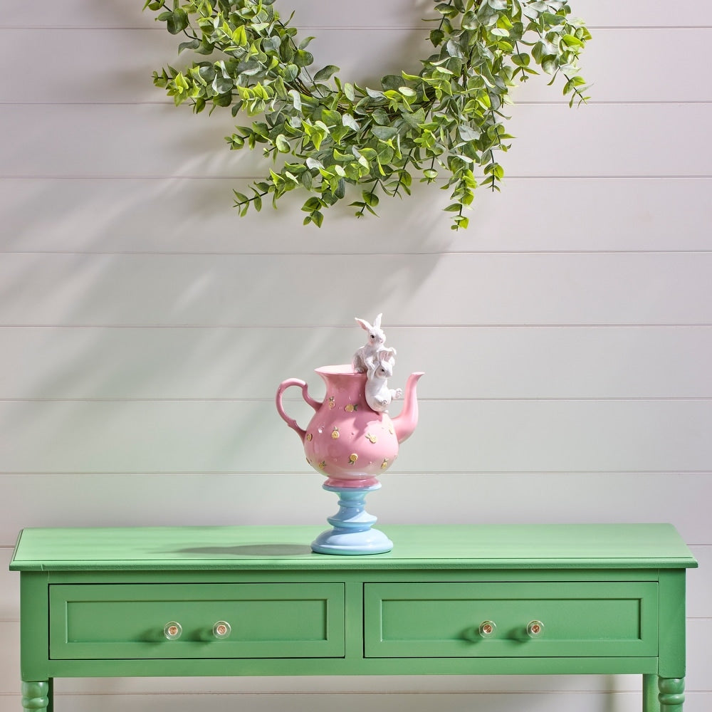Resin tea pot with playful bunny figures in white against a neutral background
