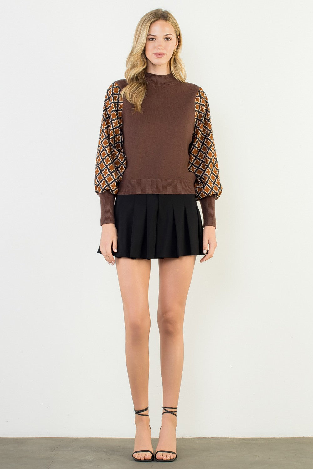 Hannah Mixed Media Knit Top in earthy tones with a relaxed silhouette featuring mixed fabric textures and short sleeves.