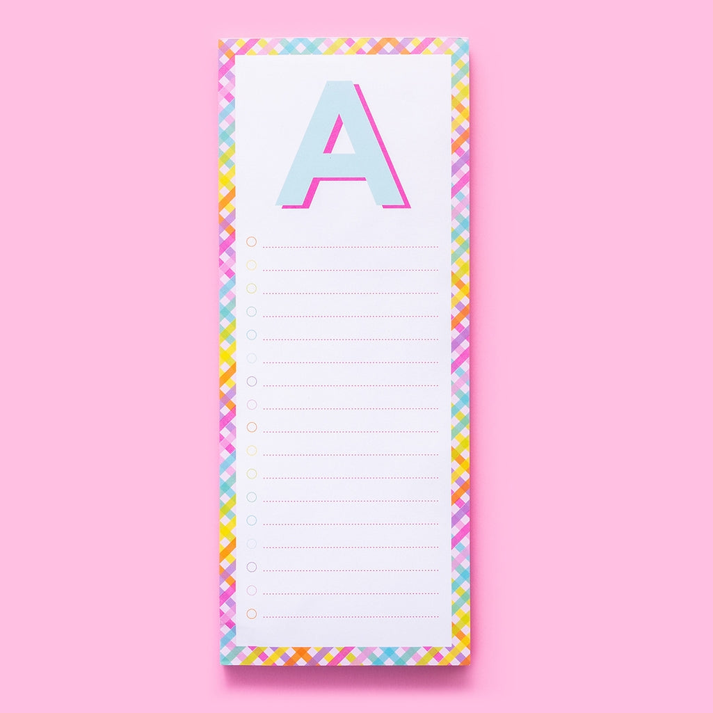 List Pad Letters: a white rectangular notepad with blue horizontal lines on the front and a magnet attached to its back.