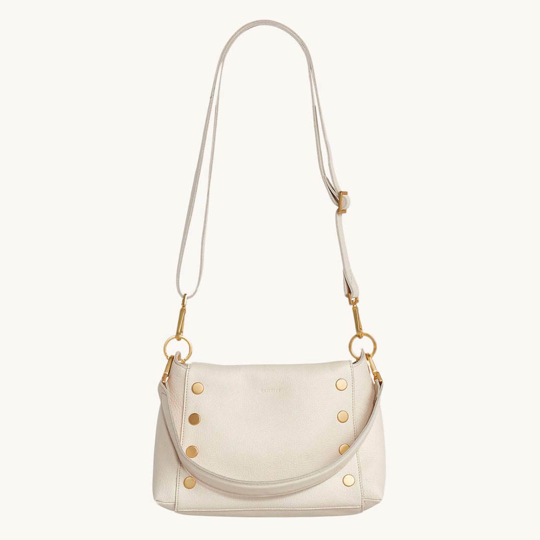 Bryant Med crossbody bag in white Calla Lily exterior with brushed gold hardware and adjustable straps.