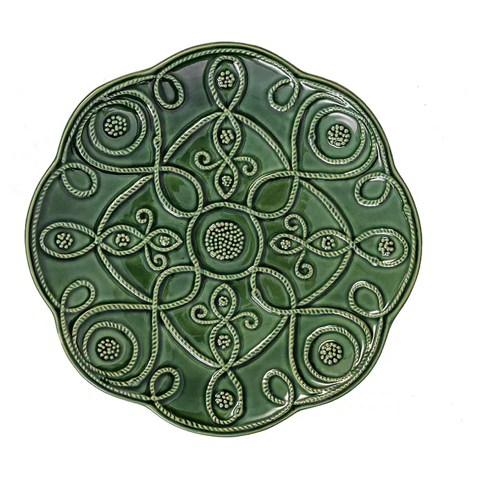 Set of four stoneware dessert plates in basil green with a subtle leaf pattern.