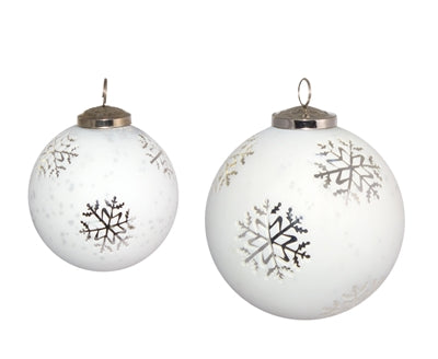 Two white glass ball ornaments with silver snowflake designs and metal hanging loops.
