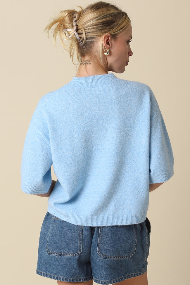 Alice Parker half-sleeve sweater in a neutral tone with a relaxed silhouette.