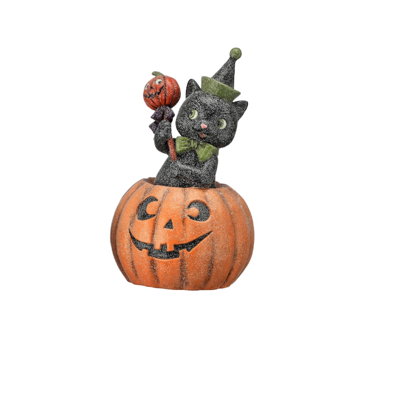 10.5-inch paper pulp black cat figurine with a sugared finish, sitting inside a jack-o'-lantern.