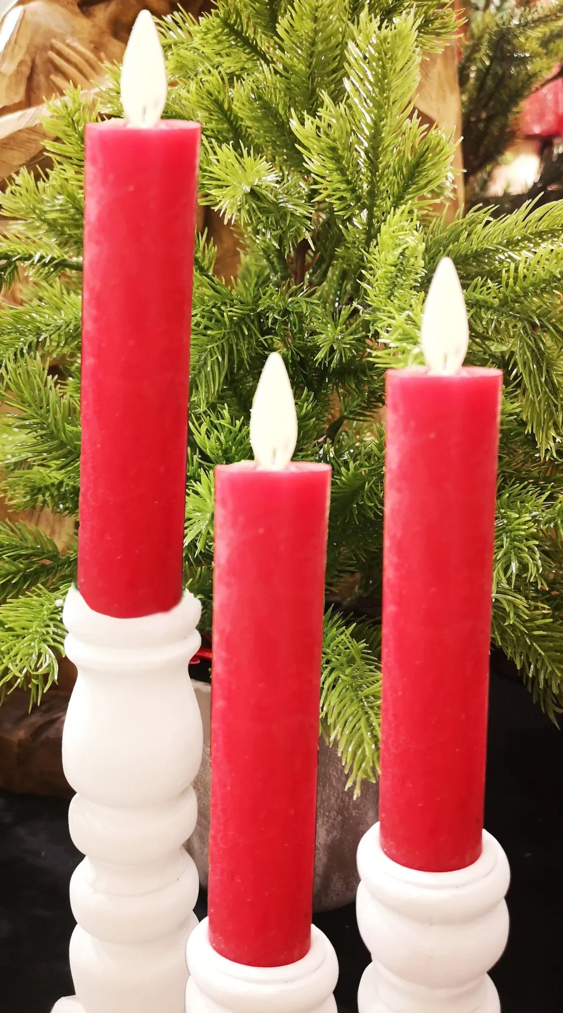 Set of three white battery-operated taper candles with realistic moving flame effect.