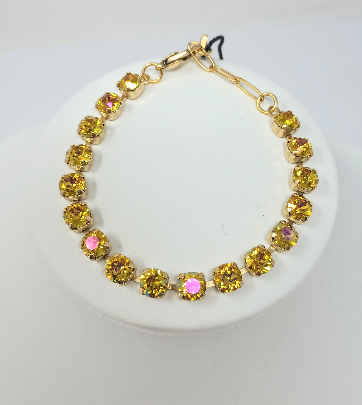 Sarina Bracelet featuring yellow and pink crystals in an antique gold-plated brass setting.