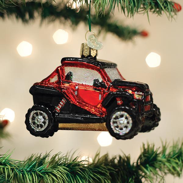 Red and black glass Side By Side ATV Christmas ornament hanging on a tree.