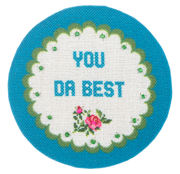 Multi-colored embroidered compact mirror with a cheeky chic circular shape.