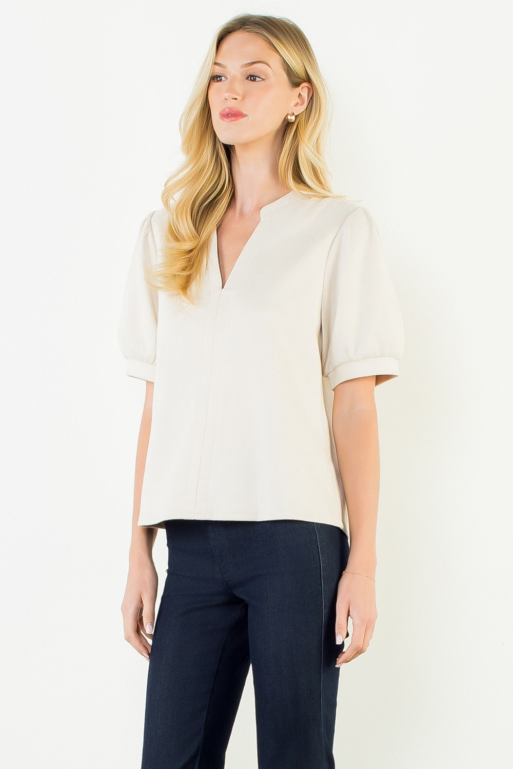 Woman wearing the Juliana Soft Suede V-Neck Top in cream with dark denim pants.