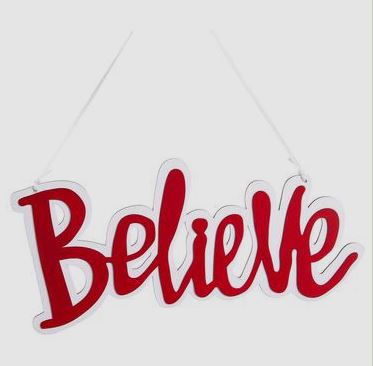 Red and white wooden 'Believe' hanging ornament with a white string.