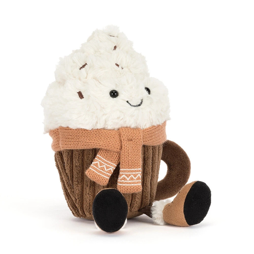 Plush hot chocolate character with white whipped cream, a brown corduroy mug, and a tan knit scarf.