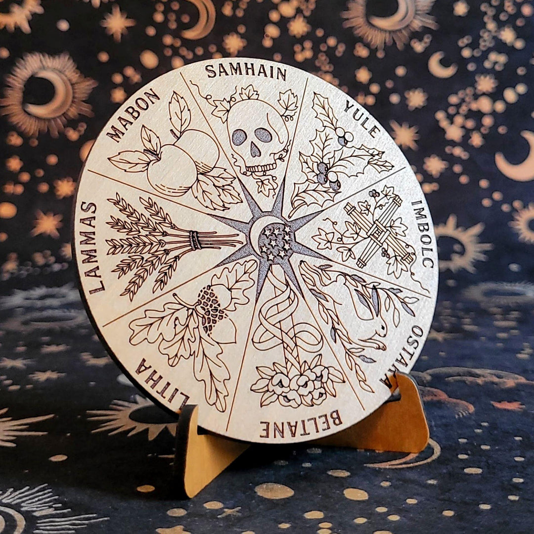 Solid wood circular Wheel of the Year with laser-etched mystical holidays on a wooden stand.