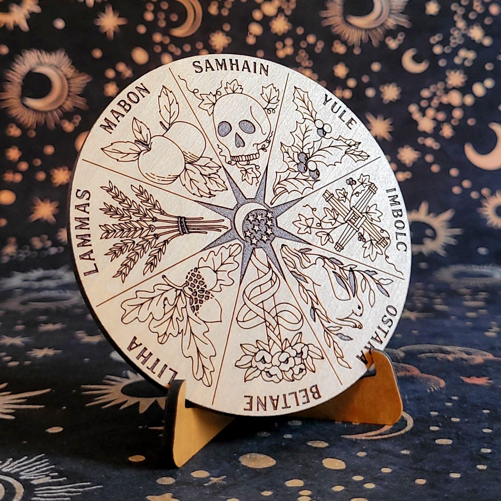 Solid wood circular Wheel of the Year with laser-etched mystical holidays on a wooden stand.