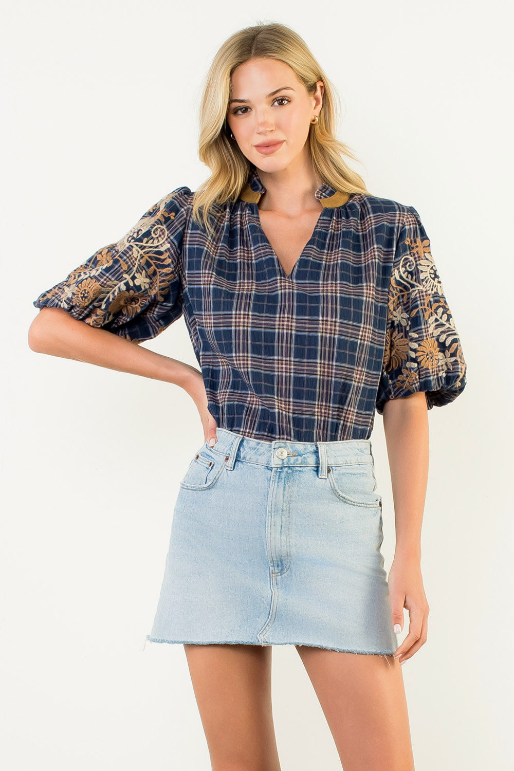 Women's gingham puff sleeve top with embroidered floral details in navy blue.