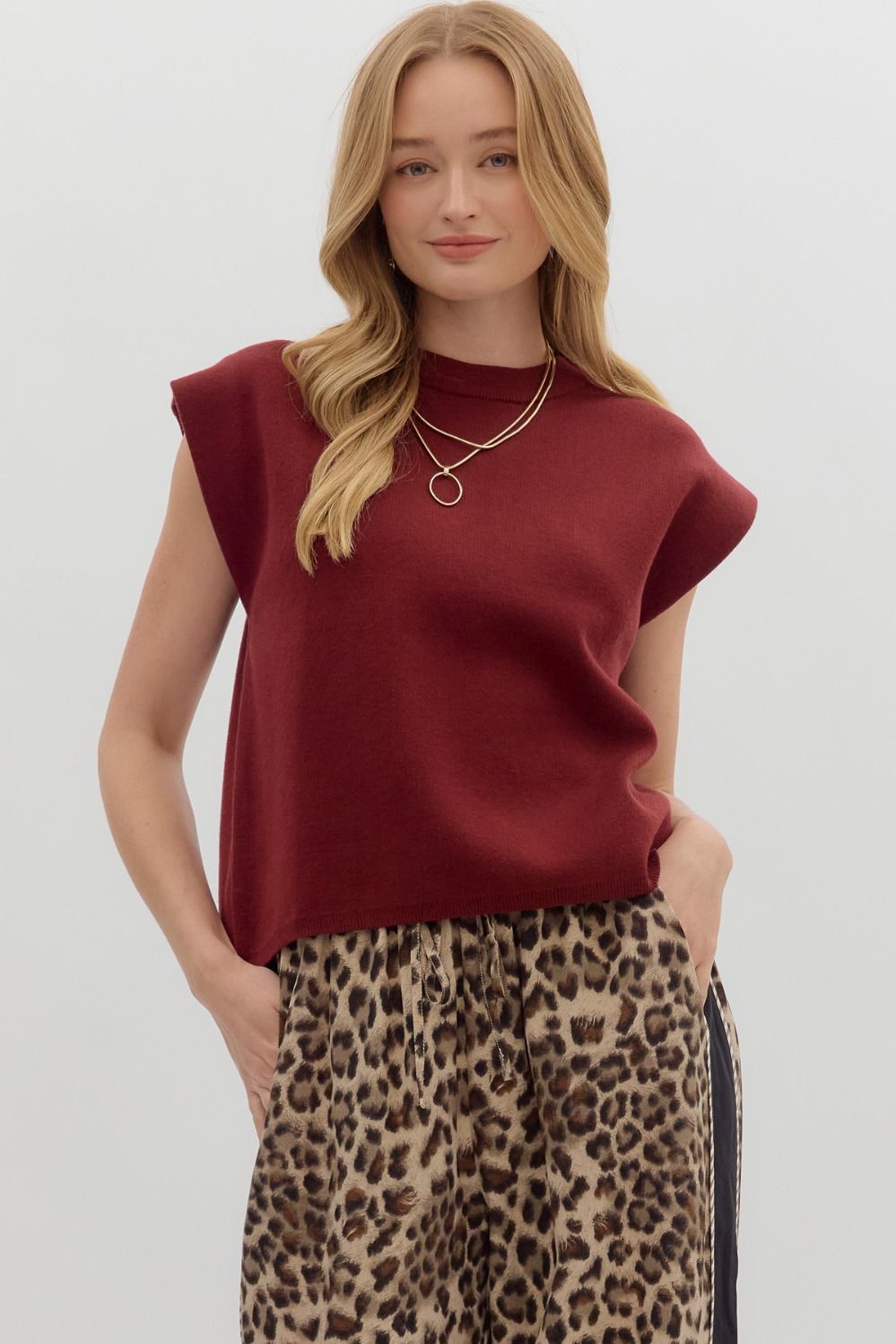Woman wearing a burgundy Olivia Solid Crewneck Sweater Knit Muscle Tee Top with leopard print pants.