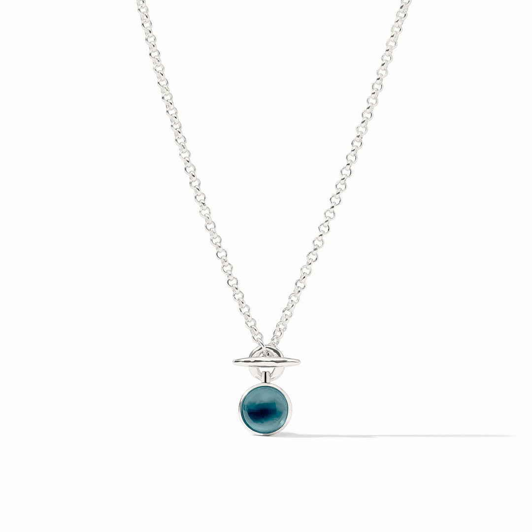Solara Solitaire Necklace with a silver chain and a round blue glass pendant.