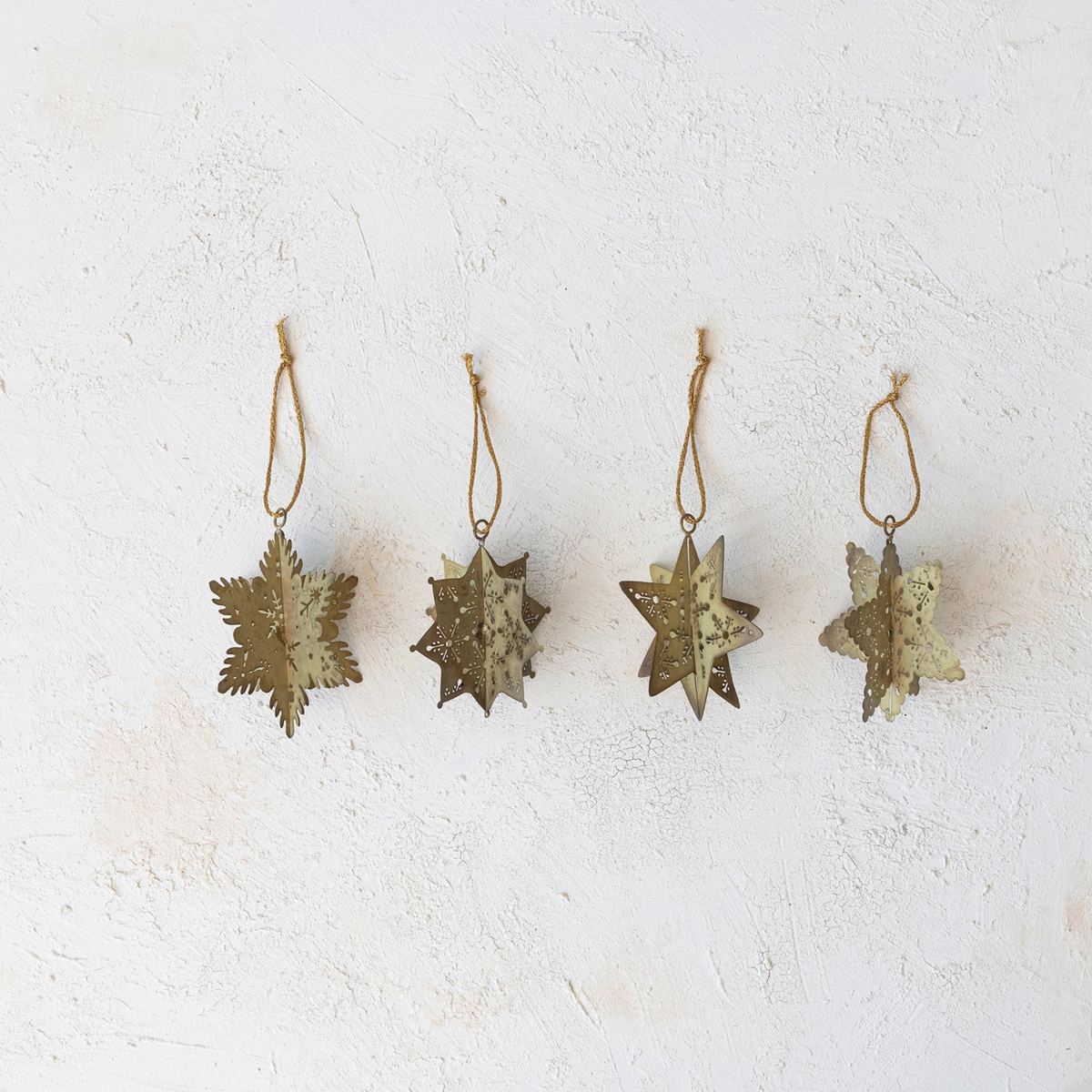 Antique gold metal snowflake ornament with cut-out patterns