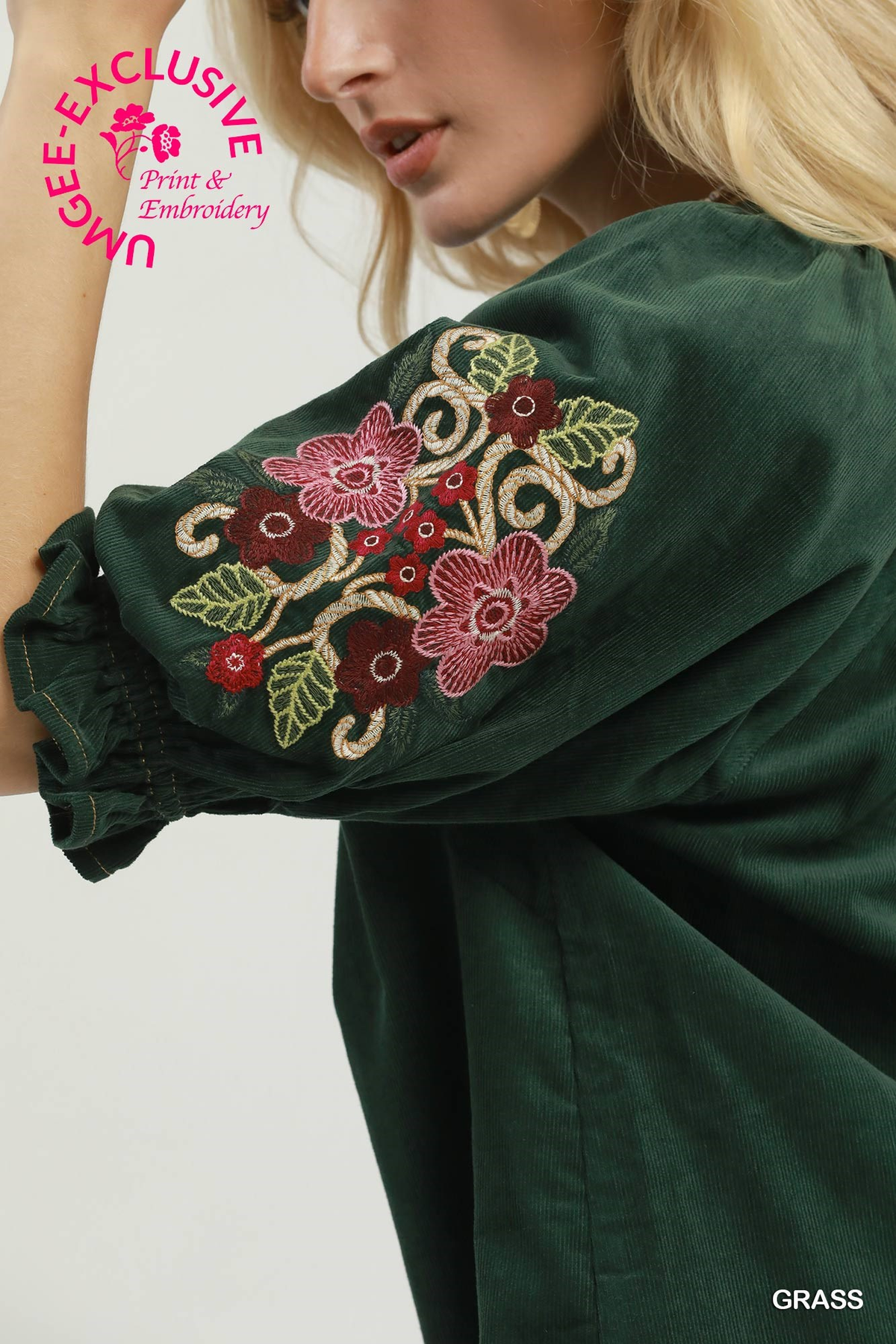 Close-up of the Eliana corduroy blouse in grass green featuring floral embroidery on the sleeve.