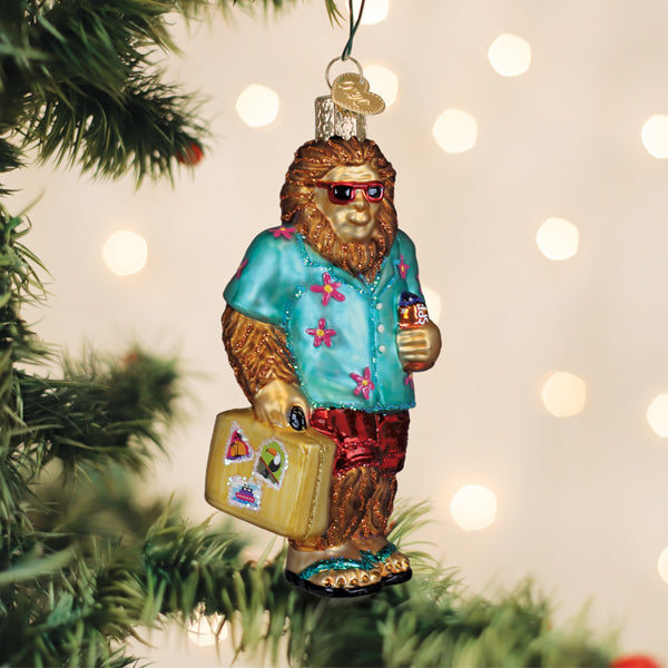 Sasquatch Gone Tropics ornament: Bigfoot figure in sunglasses with flip-flops on a tropical beach scene.