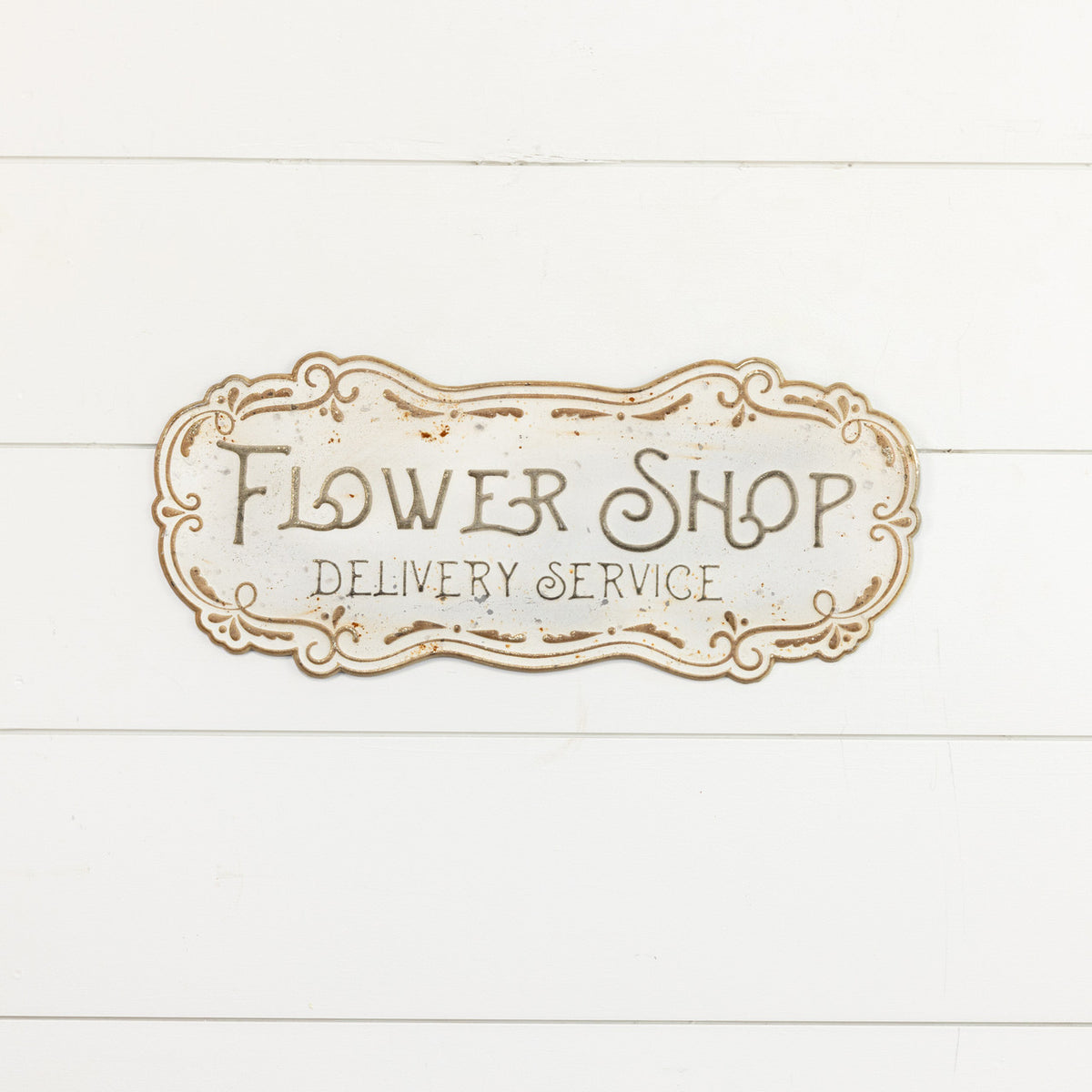 Metal flower shop sign with a floral outline design