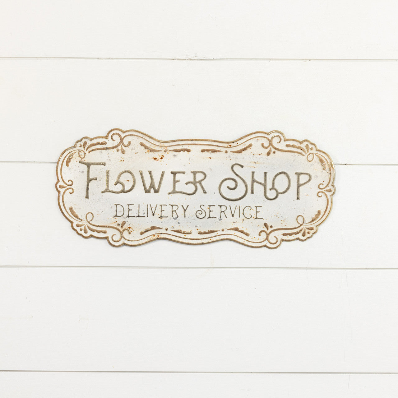Metal flower shop sign with a floral outline design