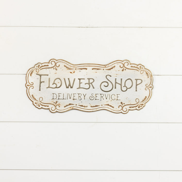 Metal flower shop sign with a floral outline design