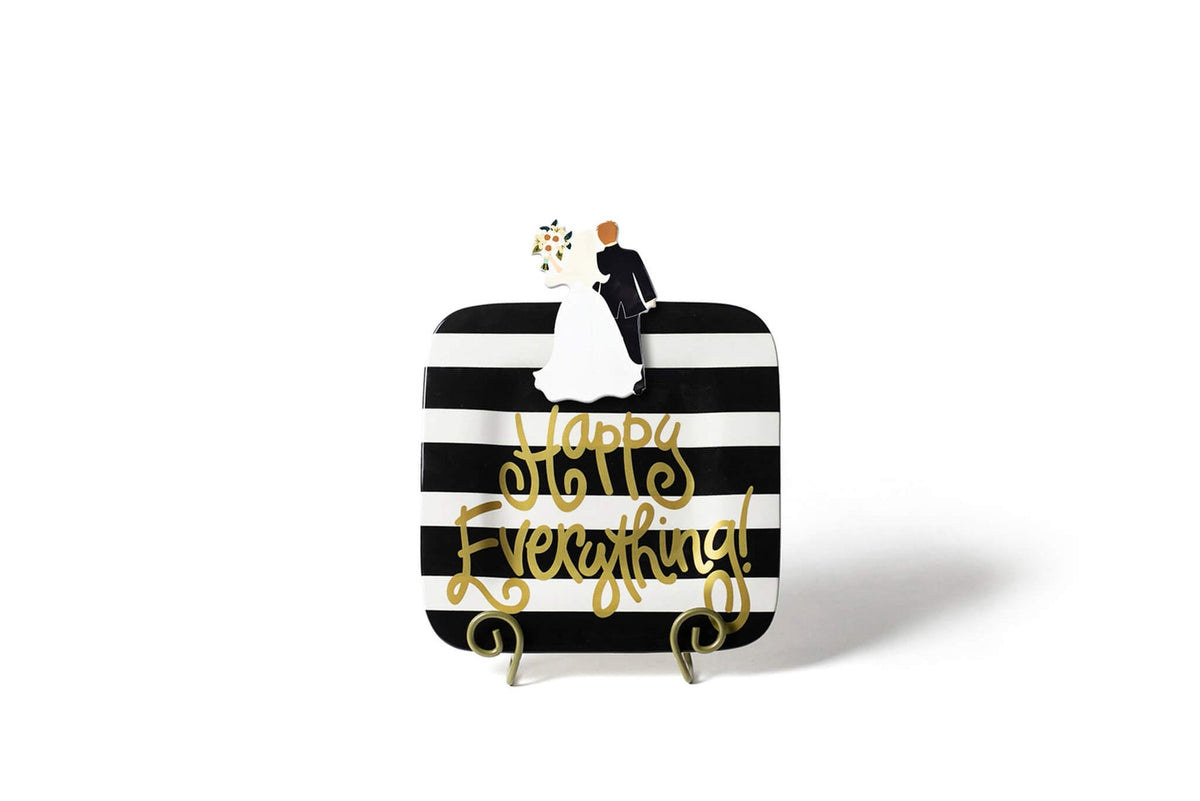 Ceramic Bride and Groom Mini Attachment on a black and white striped decorative plate.