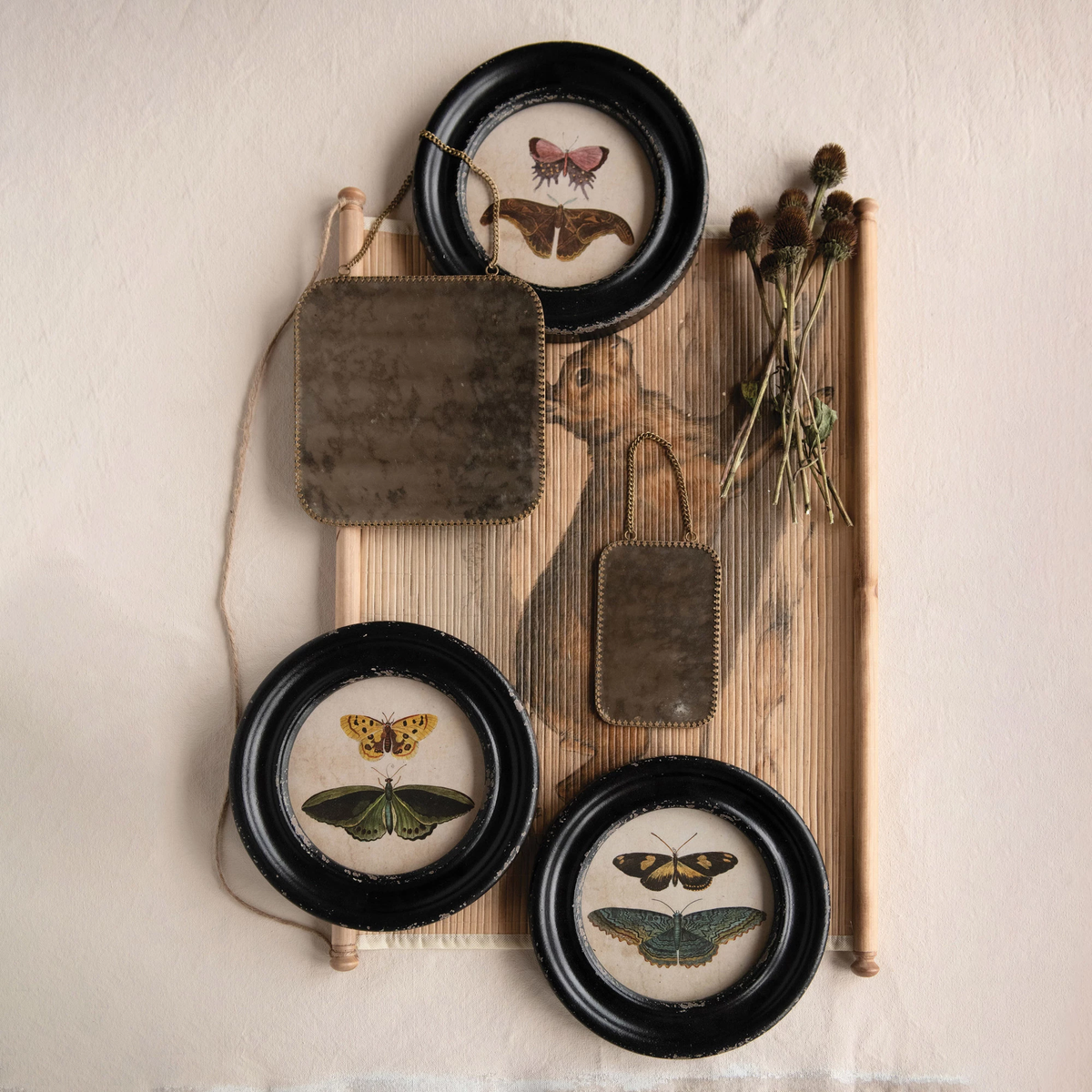 Framed wall decor featuring a black butterfly silhouette on a white background.