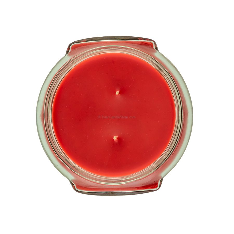 Top view of an 11oz red candle in a glass jar with two wicks.