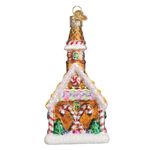 Gingerbread Church glass ornament with candy cane accents, glittery snow, and a tall steeple.