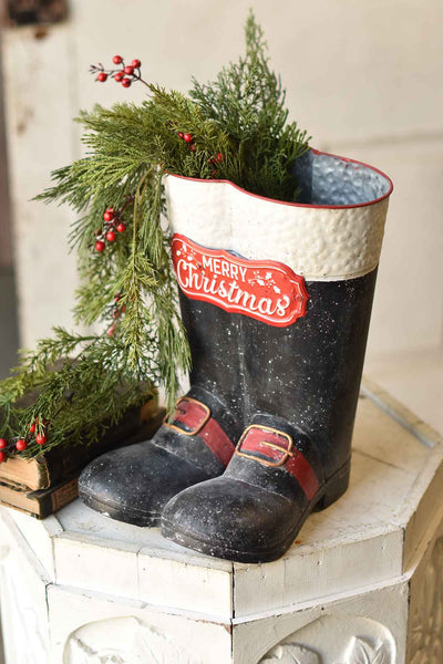Metal Merry Christmas boots with festive holiday-themed design.