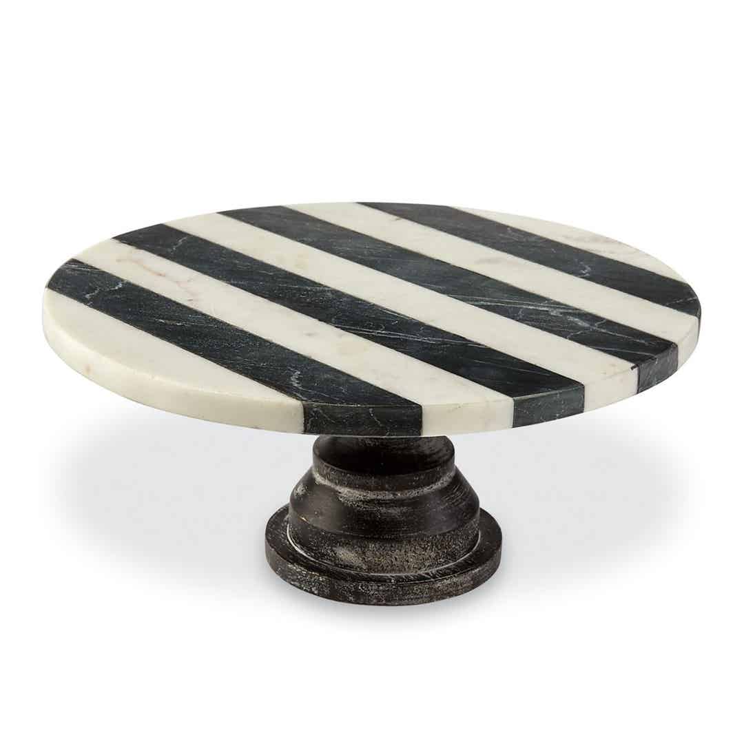 Black marble cake pedestal with white veining on a circular base