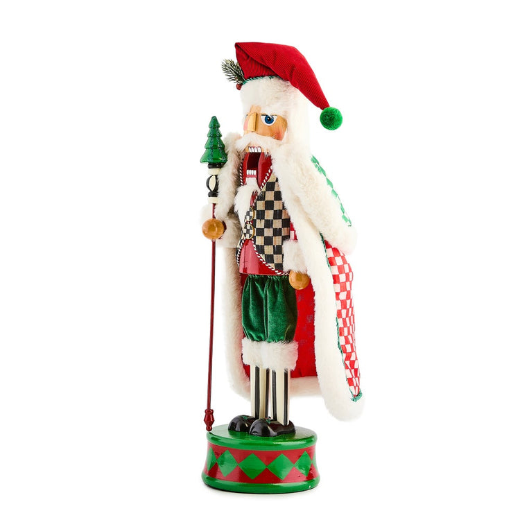 Check It Out Nutcracker in a red hat and checkered vest holding a staff with a green tree topper.