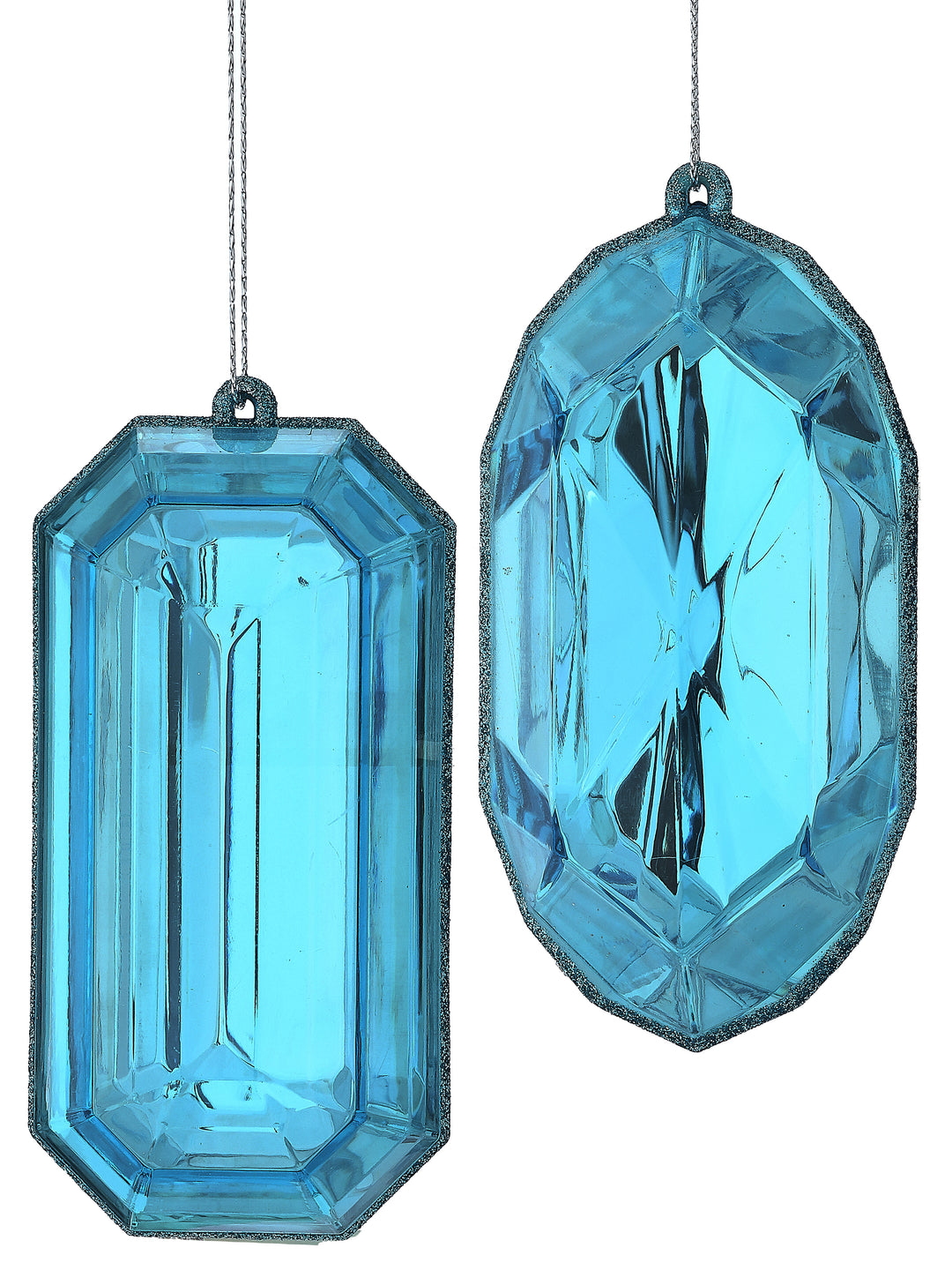 Two blue acrylic gem-shaped ornaments with faceted surfaces and glittered edges.