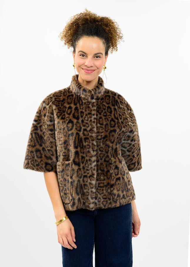 Woman wearing a leopard print Megan Faux Fur Capelet with short sleeves and a high collar.