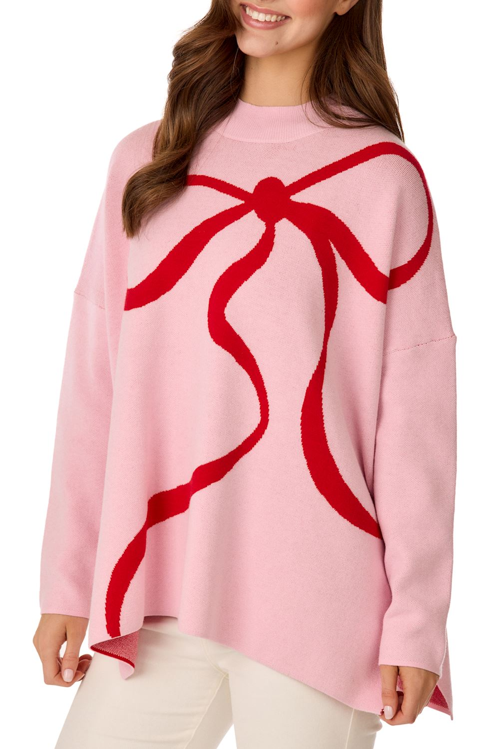 Woman wearing a pink Valentine's Jacquard Sweater with a large red bow graphic on the front.