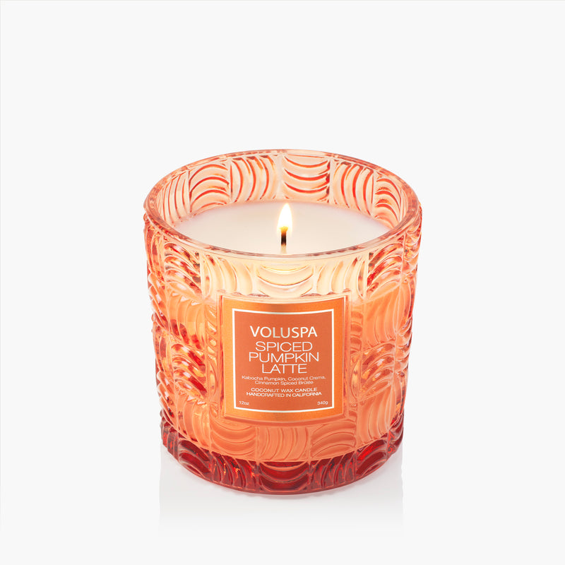 Voluspa Spiced Pumpkin Latte 12oz candle in an orange textured glass jar with a lit wick.