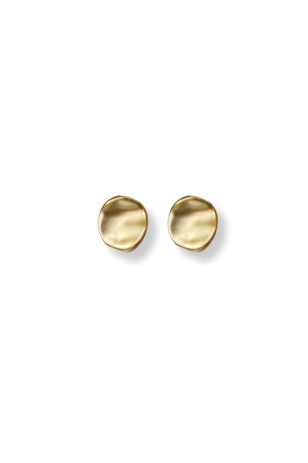 A pair of WS Nina Stud Earrings in a matte gold finish with an organic, hammered circular shape.