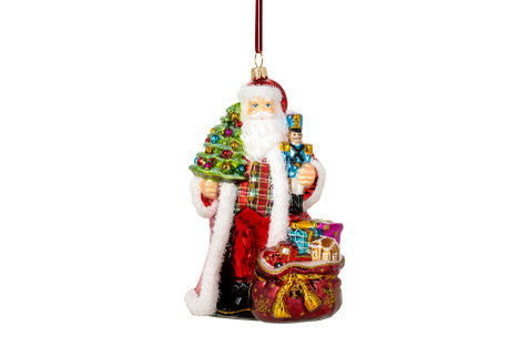 Warwick Hall Santa glass ornament holding a Christmas tree, nutcracker, and a sack of toys.