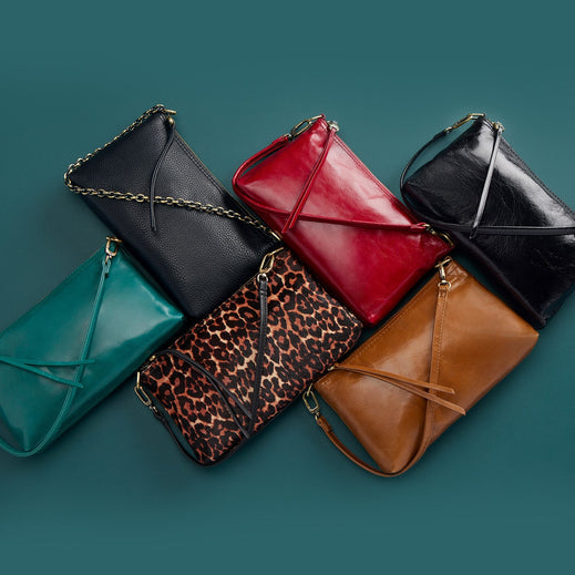 Darcy crossbody bag in solid leather with antique brass hardware featuring a zip closure and convertible strap.