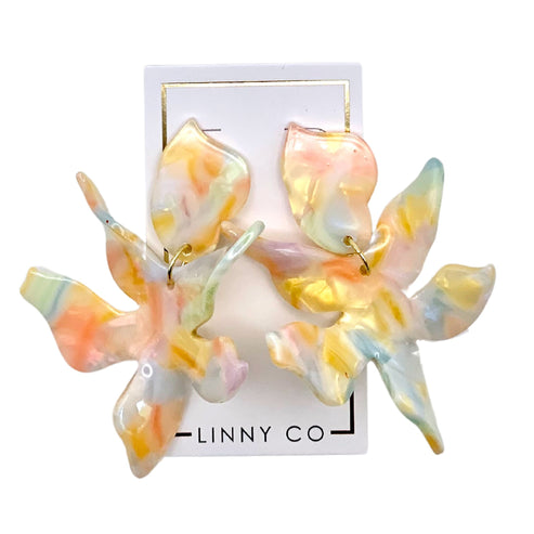 Abstract floral drop earring in light gold metal with delicate petal-shaped silhouette.