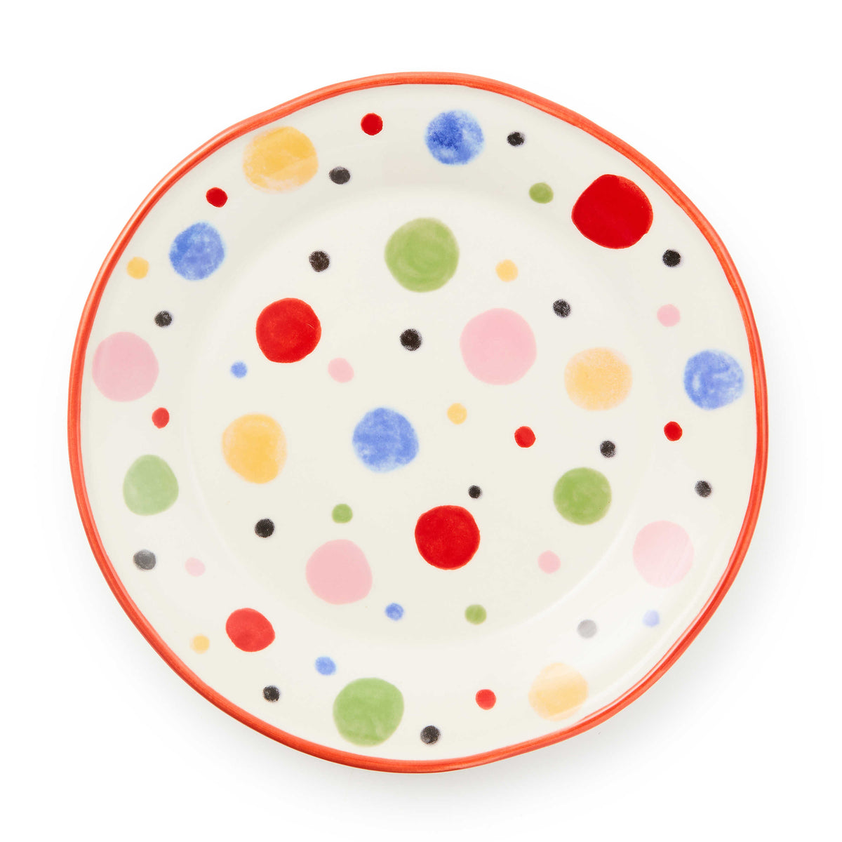 Round white stoneware salad plate with a red rim and colorful hand-painted polka dots.
