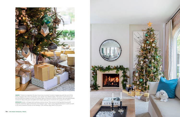 A decorated Christmas tree with gold and teal ornaments next to a fireplace and white dog on a sofa.