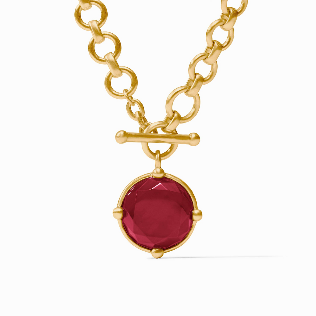 Honeybee Demi Necklace featuring a gold chain and a round rose cut red stone pendant.