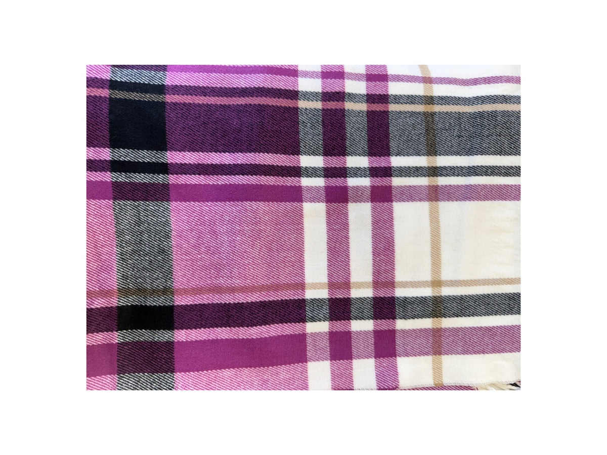 Close-up of a Scottish plaid cashmere scarf in purple, black, white, and tan check patterns.