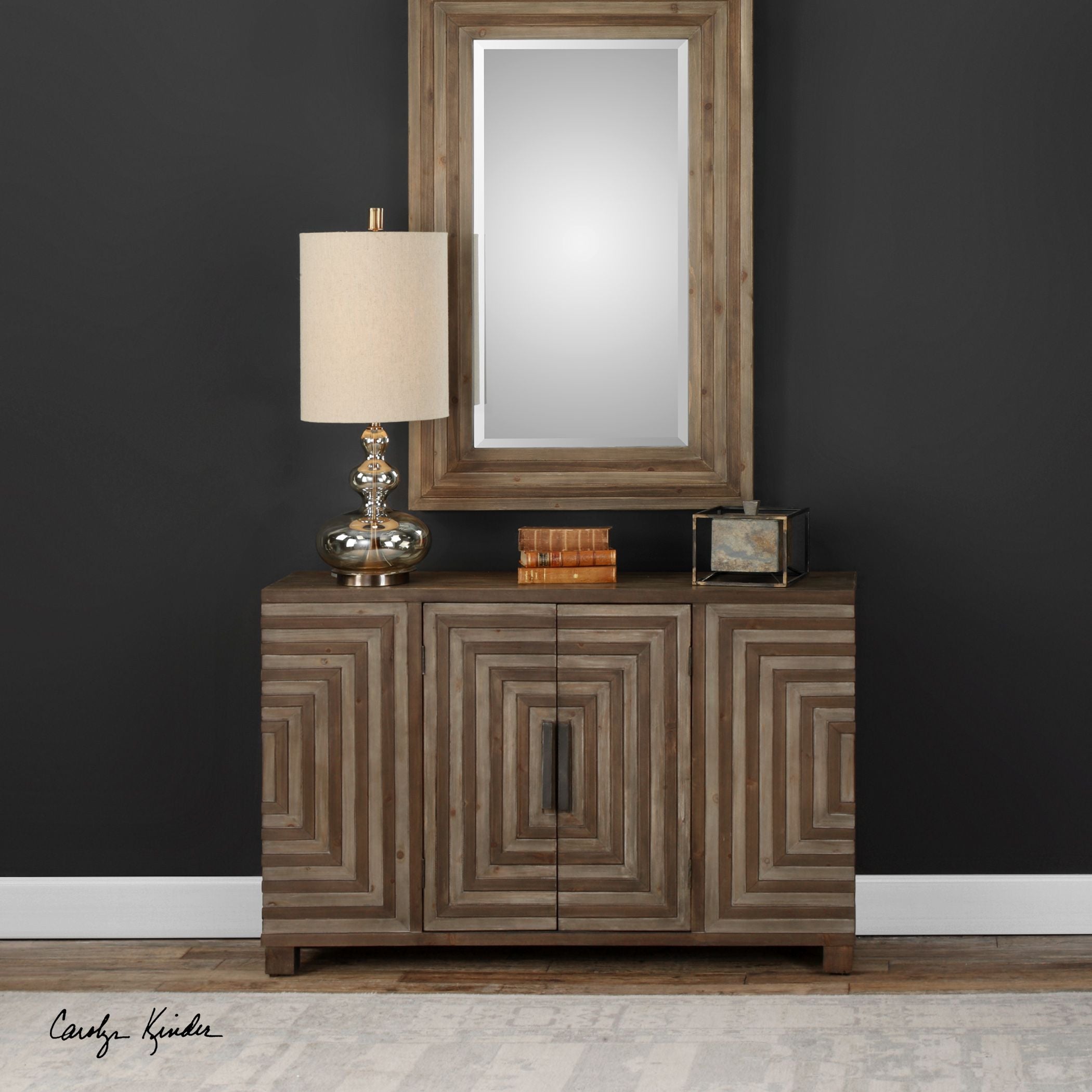 Layton Geometric Console Cabinet in light wood with a black geometric patterned front panel and tapered legs.