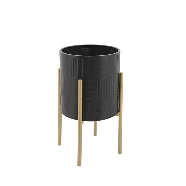 Black metal planter with gold lines on a stand